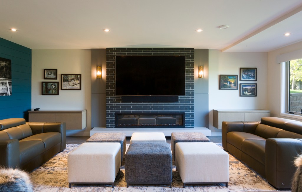 Interior painted accent wall with brick inset and linear fireplace